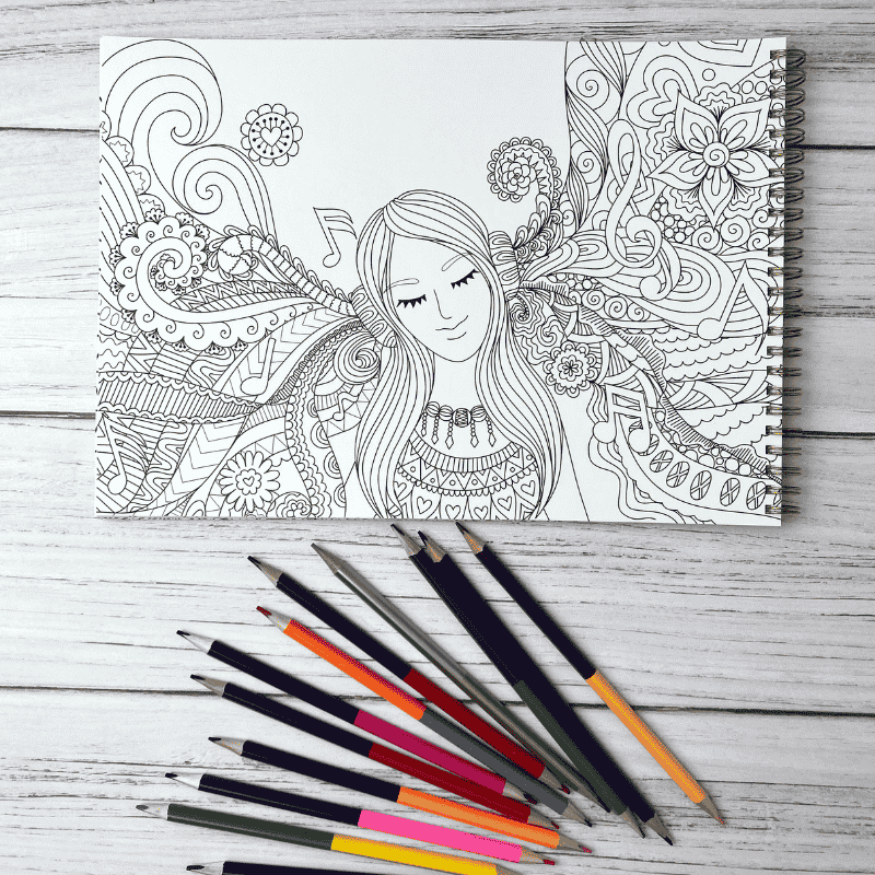 חוברת צביעה - חוברת פלא ציור מנדלה של אישה ופרחים לידו עפרונות פלא